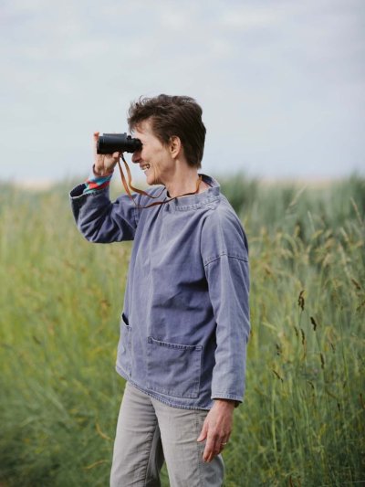 Professor Carol Brayne holding binoculars