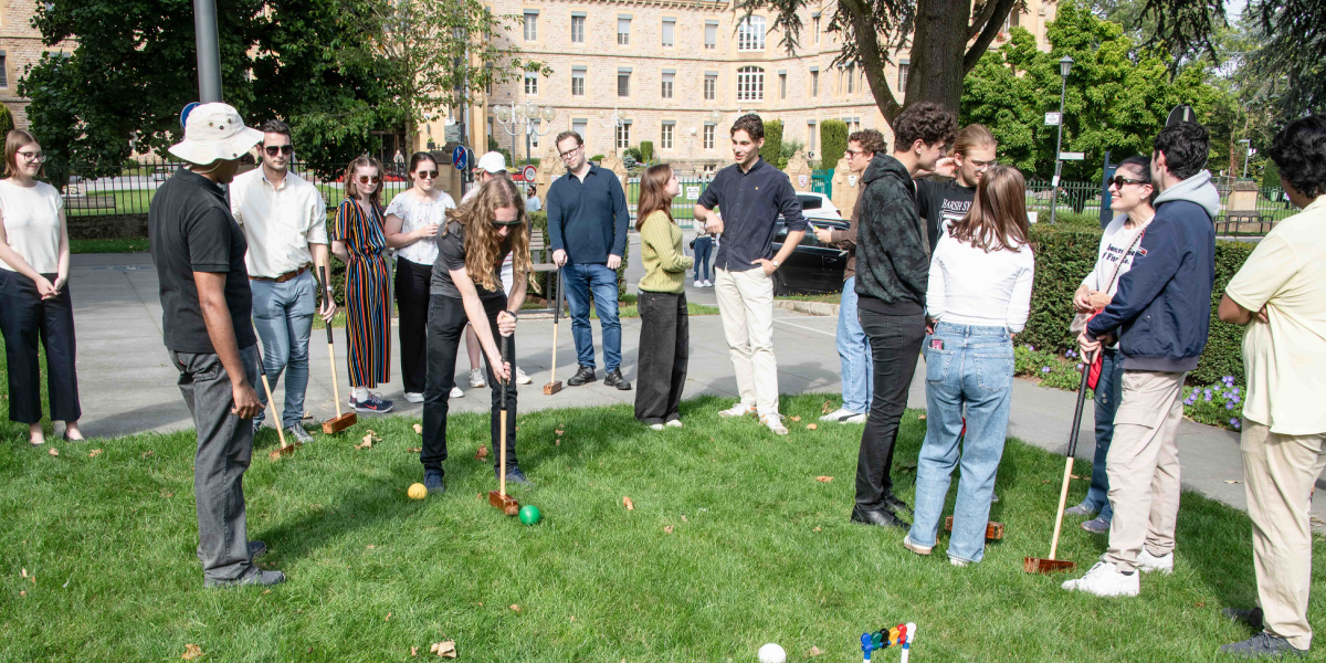 Group of people playing croquet