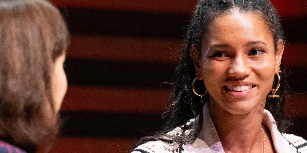 Vice Chancellor Professor Deborah Prentice in a purple check suit and alumna Vick Hope in a white striped shirt, in conversation