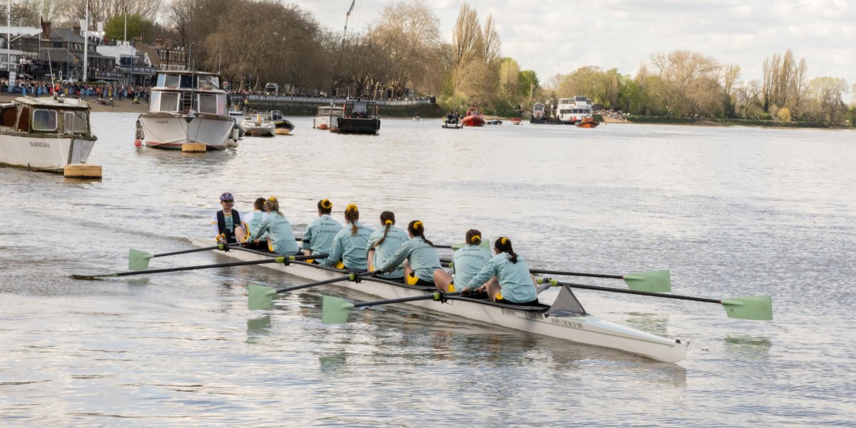 Ladies boat race team on the water preparing for their race.