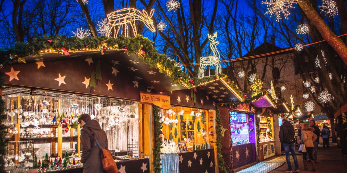 Festive market stalls being visited by the public.