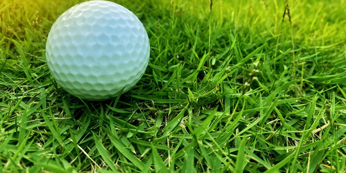 Golf ball on a grass area of golf course