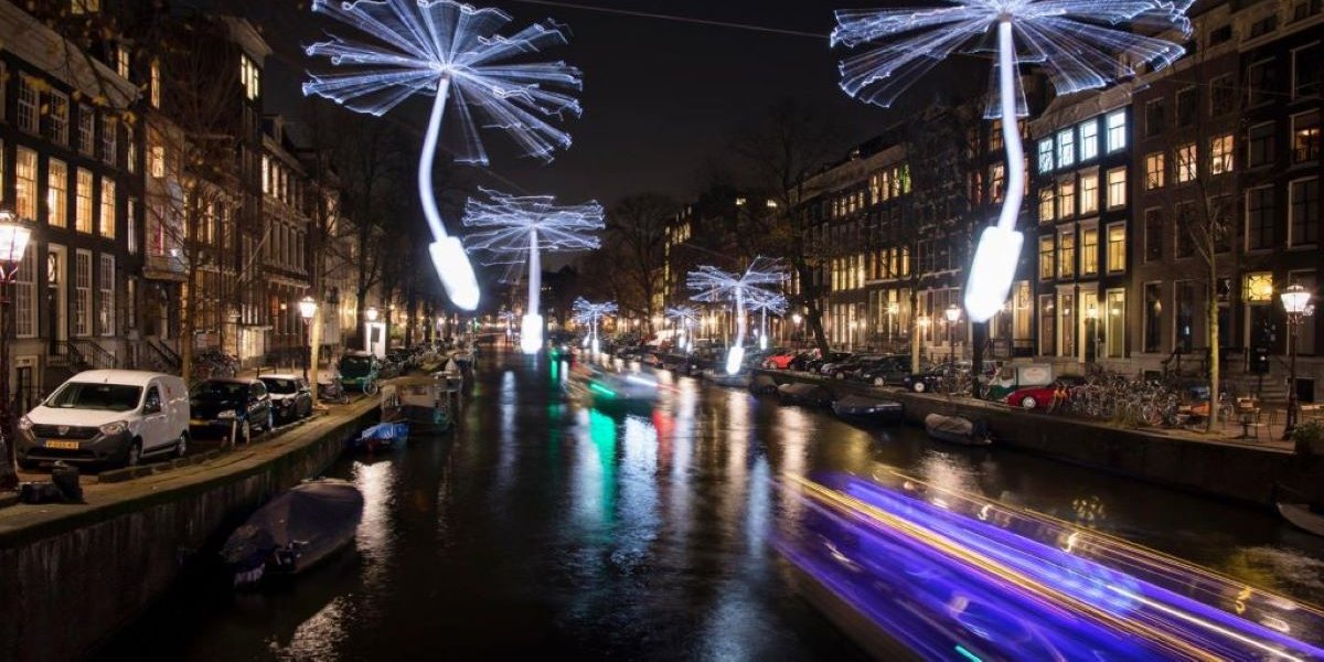 Festival lights appear in the Amsterdam night sky