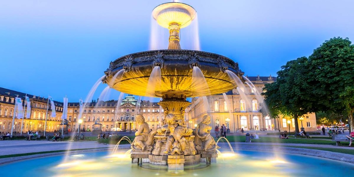 A fountain lit up at night in the German Town of Stuttgart