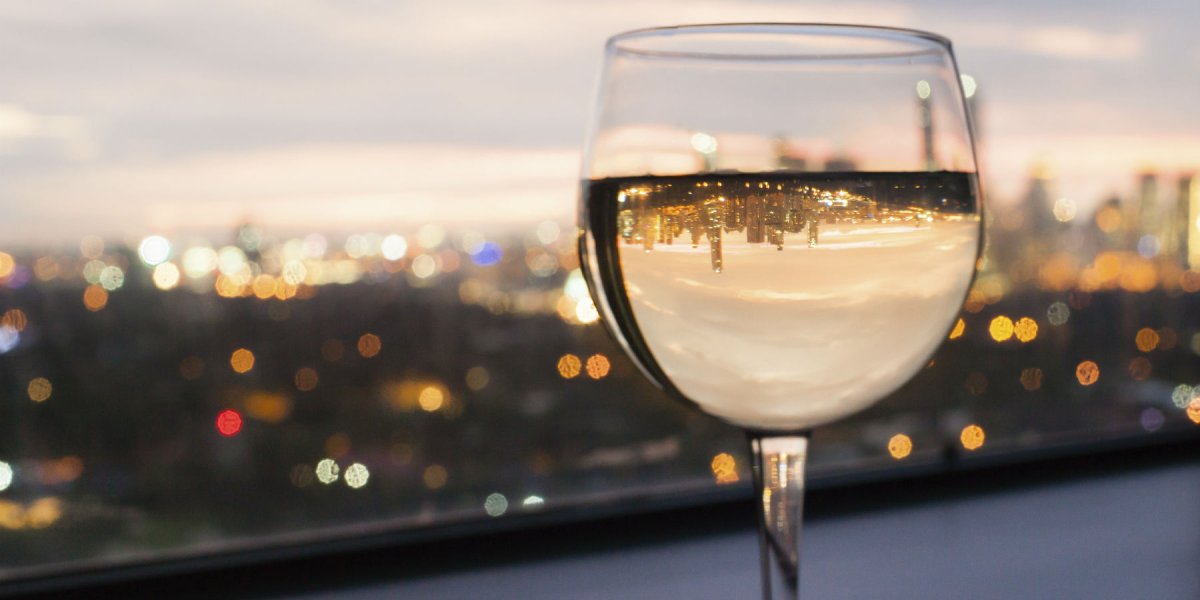 Wine glass with cityscape behind it